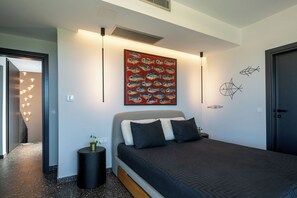 A modern bedroom with a bed, a wall art piece, and a decorative wall.