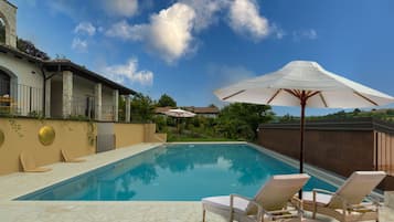 Piscine extérieure, parasols de plage, chaises longues