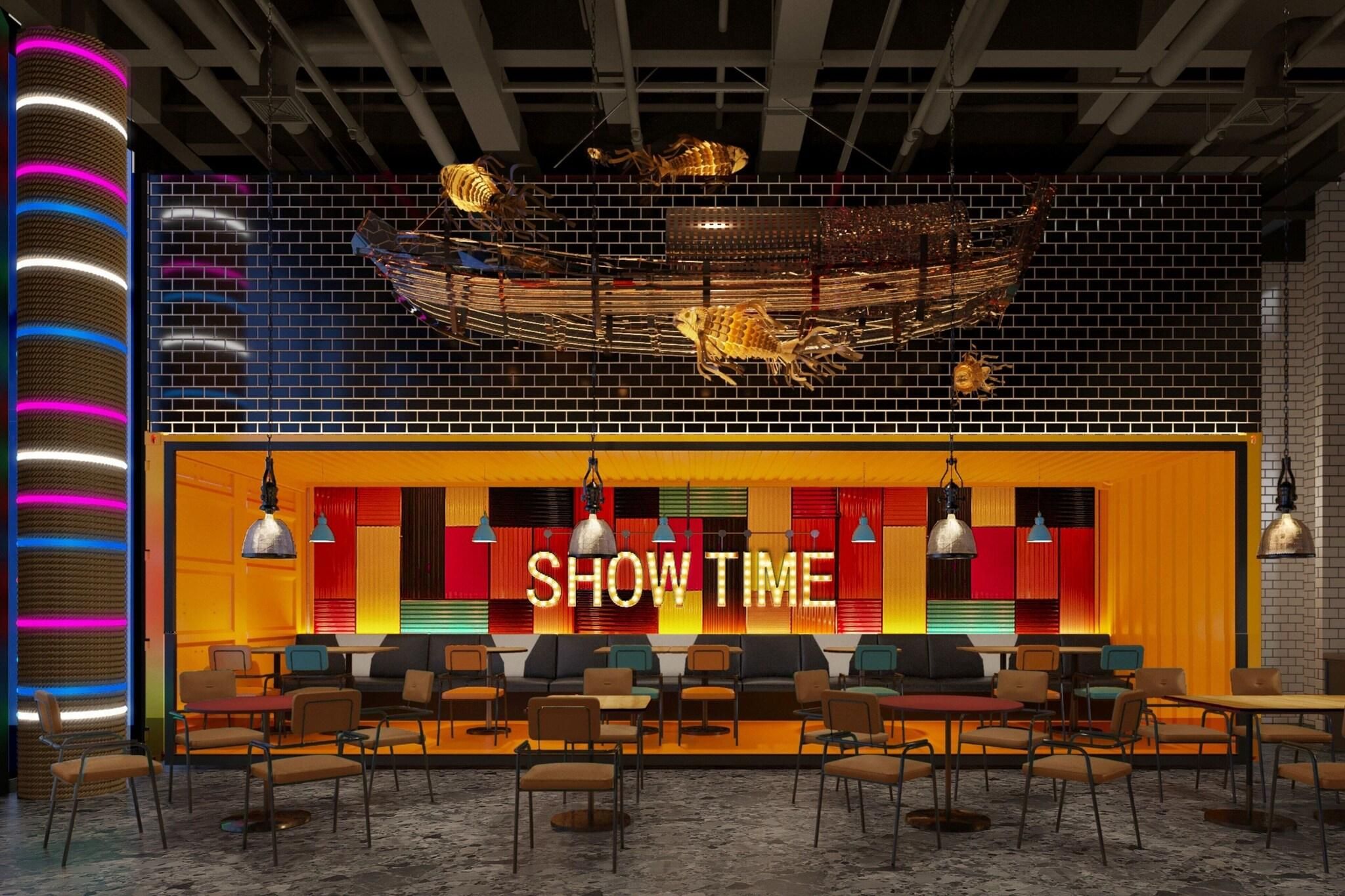 Un área de estar moderna con un cartel que dice 'SHOW TIME', asientos y elementos decorativos como una gran escultura de insecto.