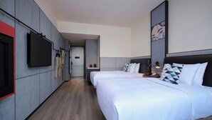 A hotel room with two beds, a flat-screen TV, a wardrobe, and a bathroom visible in the background. - Moxy Ningbo Old Bund (Ningbo)