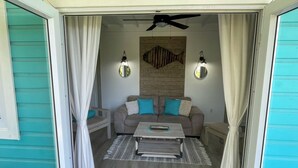 A cozy living room with a sofa, a coffee table, and two wall-mounted lamps.