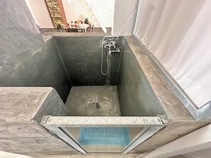 A bathtub with a showerhead and a drain. - Lu Parmientu - One Bedroom Apartment, Sleeps 2 (Parabita)