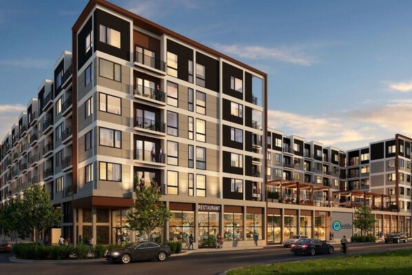 A multi-story residential building with balconies, a restaurant, and a coffee shop.