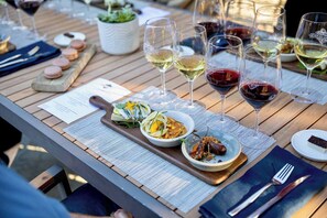 A dining table set with various dishes, wine glasses, and cutlery, indicating a meal setting. - Santa Rosa Stonehouse Private Wine Country Retreat (Santa Rosa)
