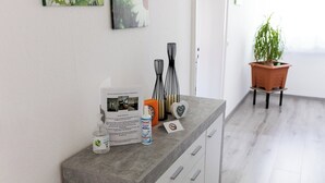 A kitchen with a grey countertop, white cabinets, and a potted plant. - Guest at Gastel's FeWo 3-6 persons gladly workers or fitters (Fischach)