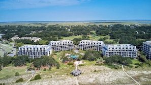 A large hotel complex with multiple buildings, a central pool area, and surrounding greenery.