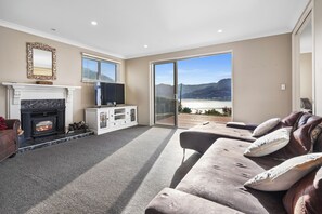 TV, fireplace - Sanctuary At The Bay - Diamond Harbour Retreat (Diamond Harbour)