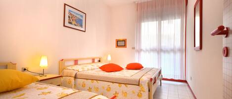 A hotel room with two beds, a window with curtains, a painting on the wall, and a tiled floor.