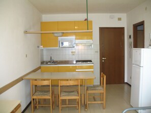 Fridge, microwave, cookware/dishes/utensils, dining tables