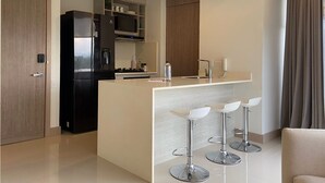 A modern kitchen with a central island, bar stools, a built-in microwave, and a refrigerator. - w Majestic 1BR w AC in Sunny Cartagena (Cartagena)
