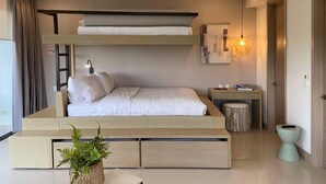 A modern bedroom with a bunk bed, bedside table, lamp, and a small plant. - w Majestic 1BR w AC in Sunny Cartagena (Cartagena)