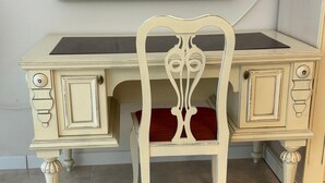 A cream-colored desk with a red cushioned chair in front. - Luxury Coastal Dreams Apartment (Свети Влас)
