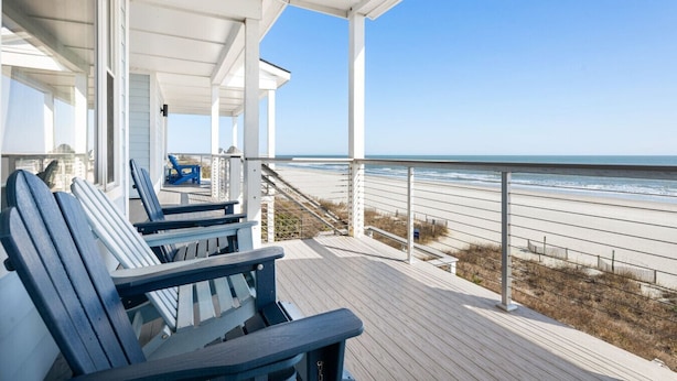 A covered deck with blue Adirondack chairs overlooking a beach. - Front Beach Condo! 1 Block to Center Street-3C (Folly Beach)