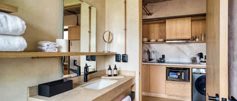 A modern bathroom with dual sinks, a large mirror, and a wooden vanity.