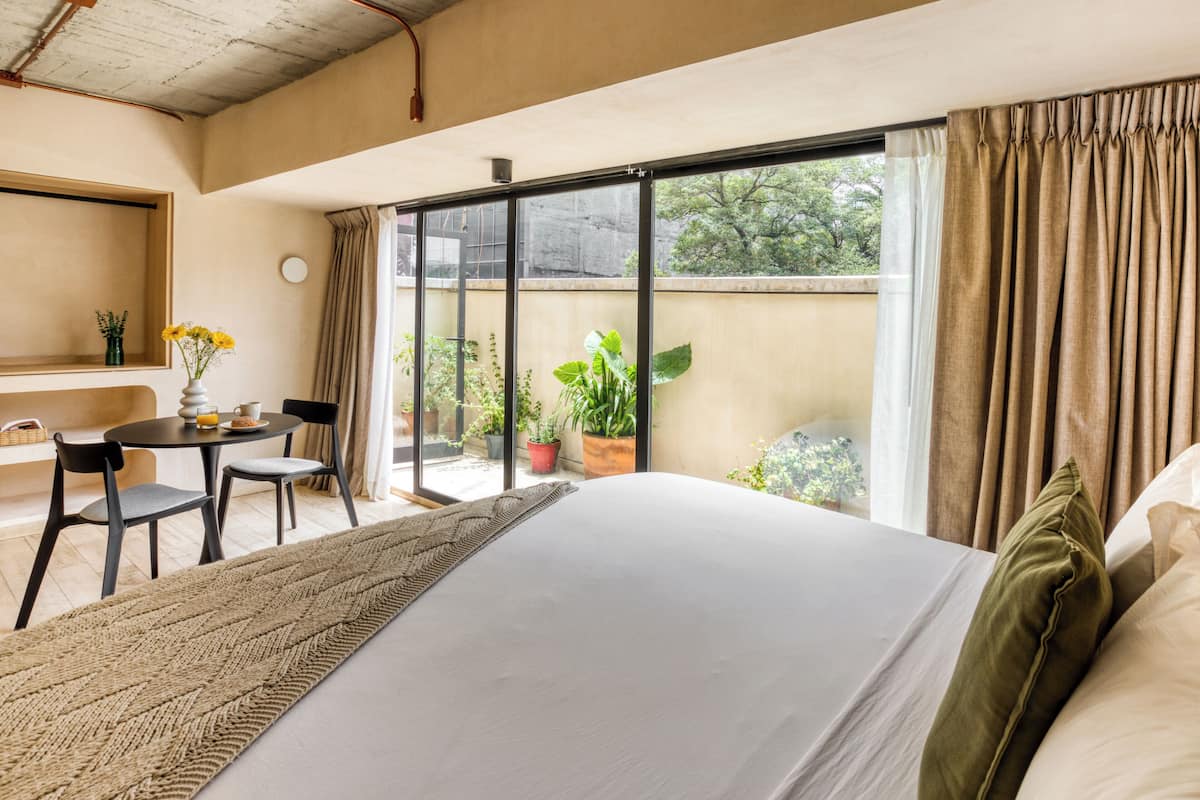 Deluxe Apartment, Patio | Minibar, in-room safe, desk, laptop workspace