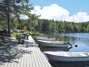 A wooden dock with several small boats moored at the end. - Ängasjö by Interhome (Östra Frölunda)