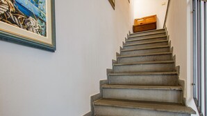 A staircase with a handrail and a wooden door at the top. - La Rondine by Interhome (San Giuliano Terme)