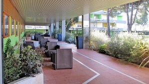 An outdoor seating area with wicker furniture and potted plants. - Apartment Italia by Interhome (Bocca di Magra)