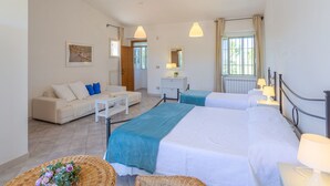 A hotel room with a bed, a sofa, a desk, and a window. - Masseria Difesa Grande by Interhome (Montenero di Bisaccia)
