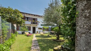 A house with a garden, a paved pathway, and outdoor furniture. - Il Castelliere by Interhome (Rive d’Arcano)