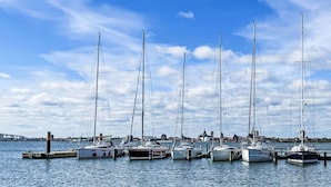 A marina with multiple sailboats docked at wooden piers. - Achterblick 2 by Interhome (Seebad Altefähr)