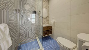 A bathroom with a shower, toilet, and sink. - Westlake Hotel - The Art Suite (Etobicoke)
