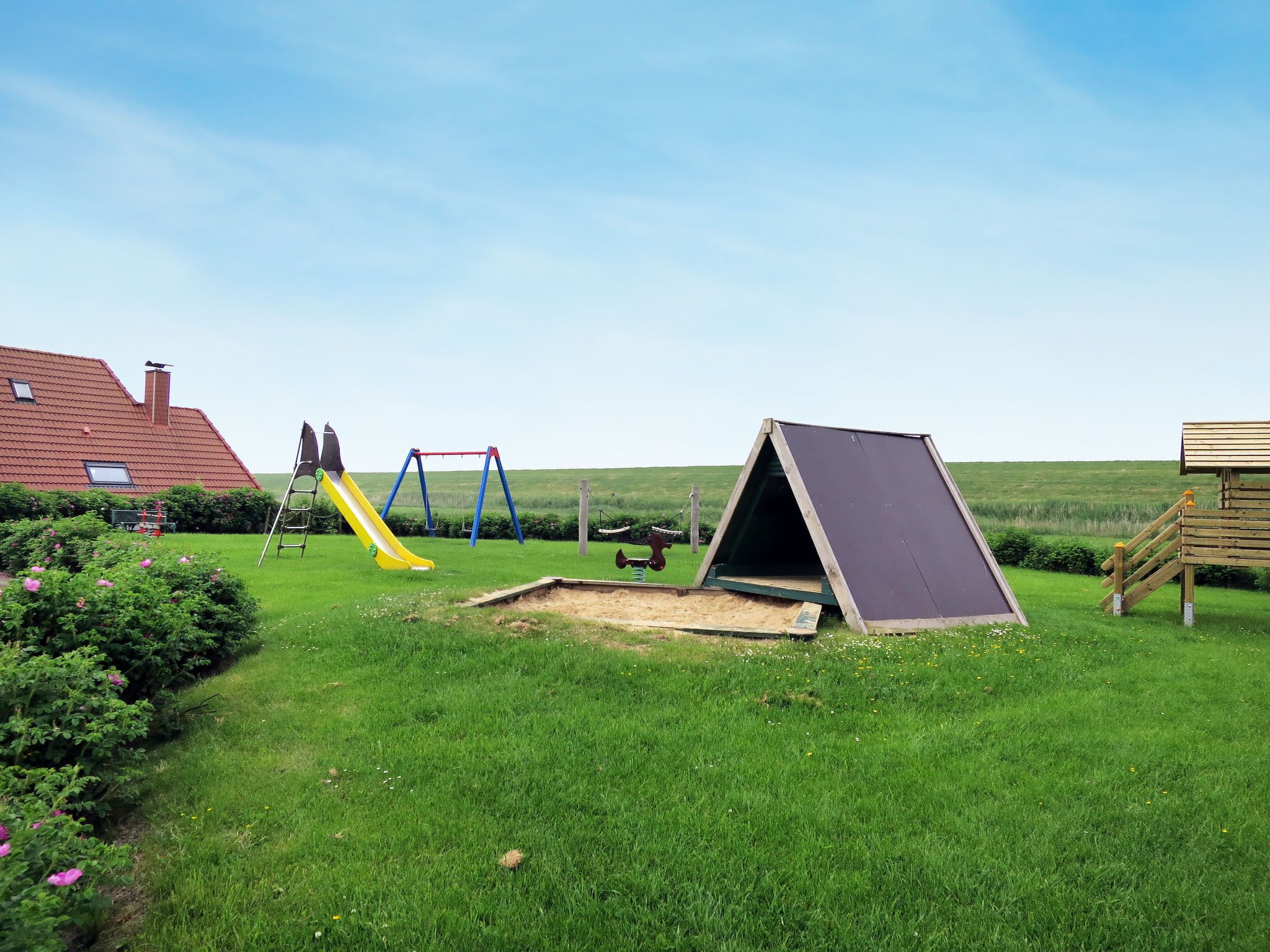 A playground with a slide, swings, and a climbing structure.