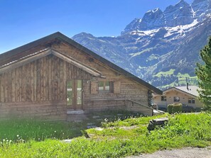 A wooden cabin with a sloped roof, a small window, and a door.