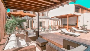 An outdoor patio area with wicker furniture, a pool, and a covered seating area. - Maré do Frances (Marechal Deodoro)