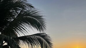 A rooftop terrace with a pool, lounge chairs, and tables, overlooking a sunset. - Maré do Frances (Marechal Deodoro)