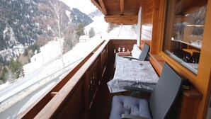 A wooden cabin with a balcony overlooking a snowy mountain landscape. - Piz Munschuns by Interhome (Spiss-Samnaun)