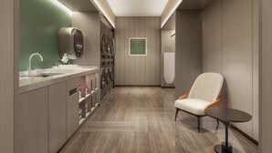 A modern bathroom with a sink, mirror, and wall-mounted washing machine. - EVEN Hotel Linyi Airport Zone by IHG (Linyi)