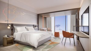 A modern hotel room with a large bed, a desk, and a view of the sky. - EVEN Hotel Linyi Airport Zone by IHG (Linyi)