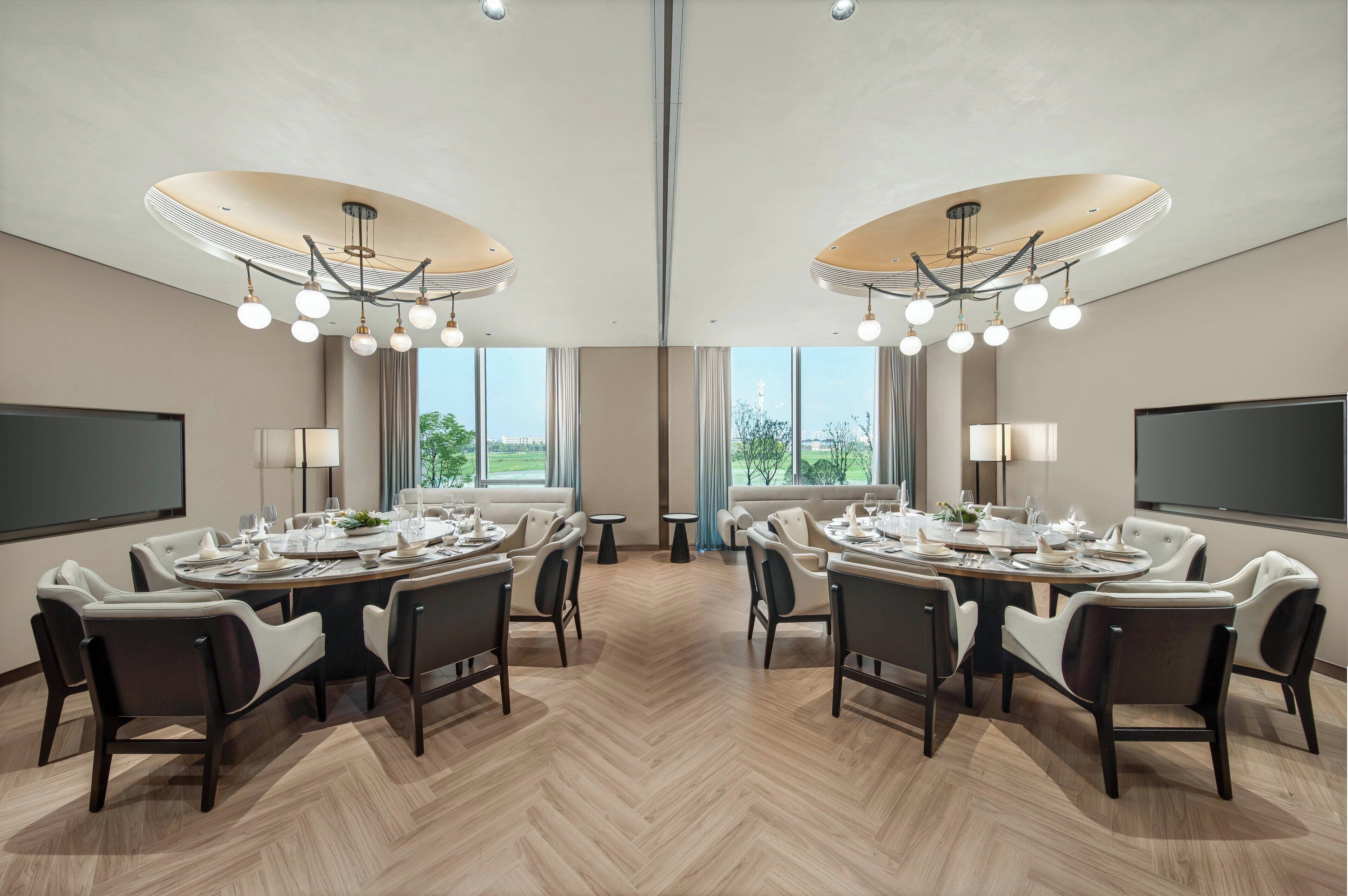 A conference room with a large table, chairs, and a chandelier.