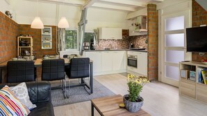 A modern living room with a sofa, chairs, a coffee table, and a TV. - De Schans by Interhome (Lauwersoog)