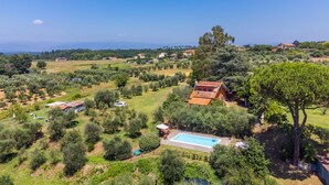 A rural landscape with a swimming pool surrounded by trees and a few buildings. - Podere Cerbaia (SMR100) by Interhome (Santa Maria al Monte)