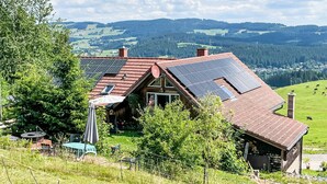A house with a sloped roof, solar panels, and a view of a green valley. - Mühlenmichelshäusle by Interhome (Hinterzarten)
