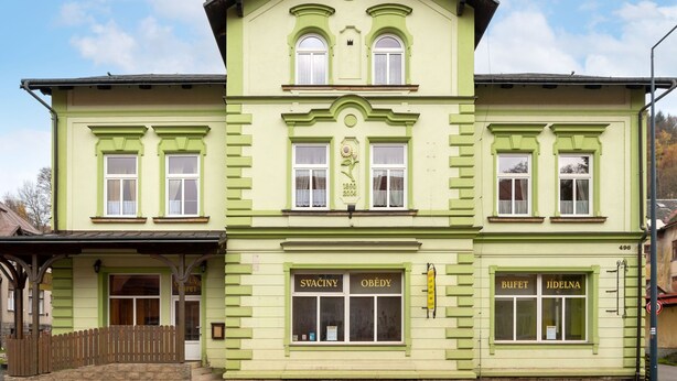 A two-story building with a green facade, featuring a shop on the ground floor and a restaurant on the upper floor. - Base Camp 1 by Interhome (Desná v Jizerských horách)