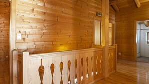 A wooden interior with a reception desk, wooden walls, and a wooden floor. - Vacation home Naulaz by Interhome (Les Crosets)