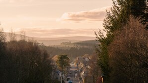 A road leading through a town with buildings on either side.
