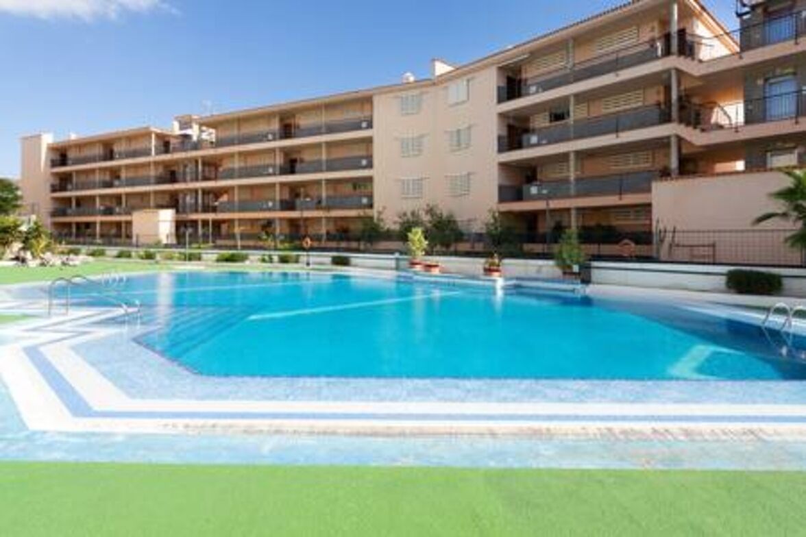 A multi-story hotel with a swimming pool.