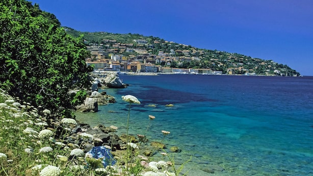 A coastal town with clear waters, rocky shoreline, and buildings on a hillside. - Three-room apartment by Interhome (Monte Argentario)
