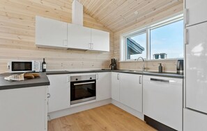 Fridge, stovetop, dishwasher, coffee/tea maker