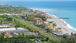 Un pueblo costero con playa, edificios y un muelle.