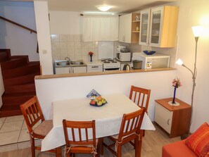 Cozy living space with a dining area, sofa, and kitchenette.