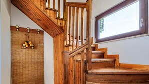 A wooden staircase with a handrail and a window with a view of the sky. - Vacation home Lancin by Interhome (Pula/Marčana)