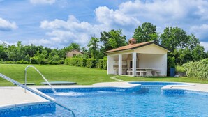 A swimming pool with a covered seating area and a small pavilion. - Apartment Macini by Interhome (Rovinj)