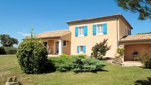 A two-story house with a tiled roof, blue shutters, and a well-maintained lawn. - Plan du Vas by Interhome (Valreas)