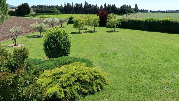 A well-maintained grassy area with various trees and shrubs, likely part of a landscaped garden or park. - Plan du Vas by Interhome (Valreas)