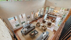 A spacious open-plan living area with a kitchen, dining area, and seating arrangements. - Featured on Staycation: The Overlook | Pool, Pickleball, ATV Access & Views (Broken Bow)